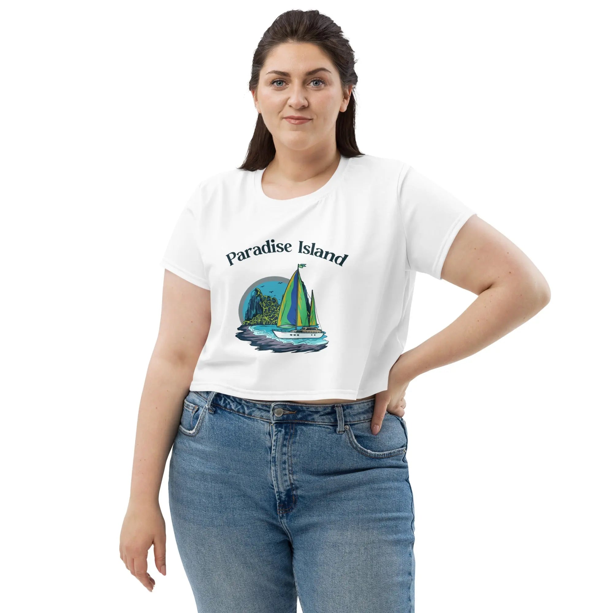 Woman wearing Paradise Island all-over print crop tee with sailboat graphic and jeans