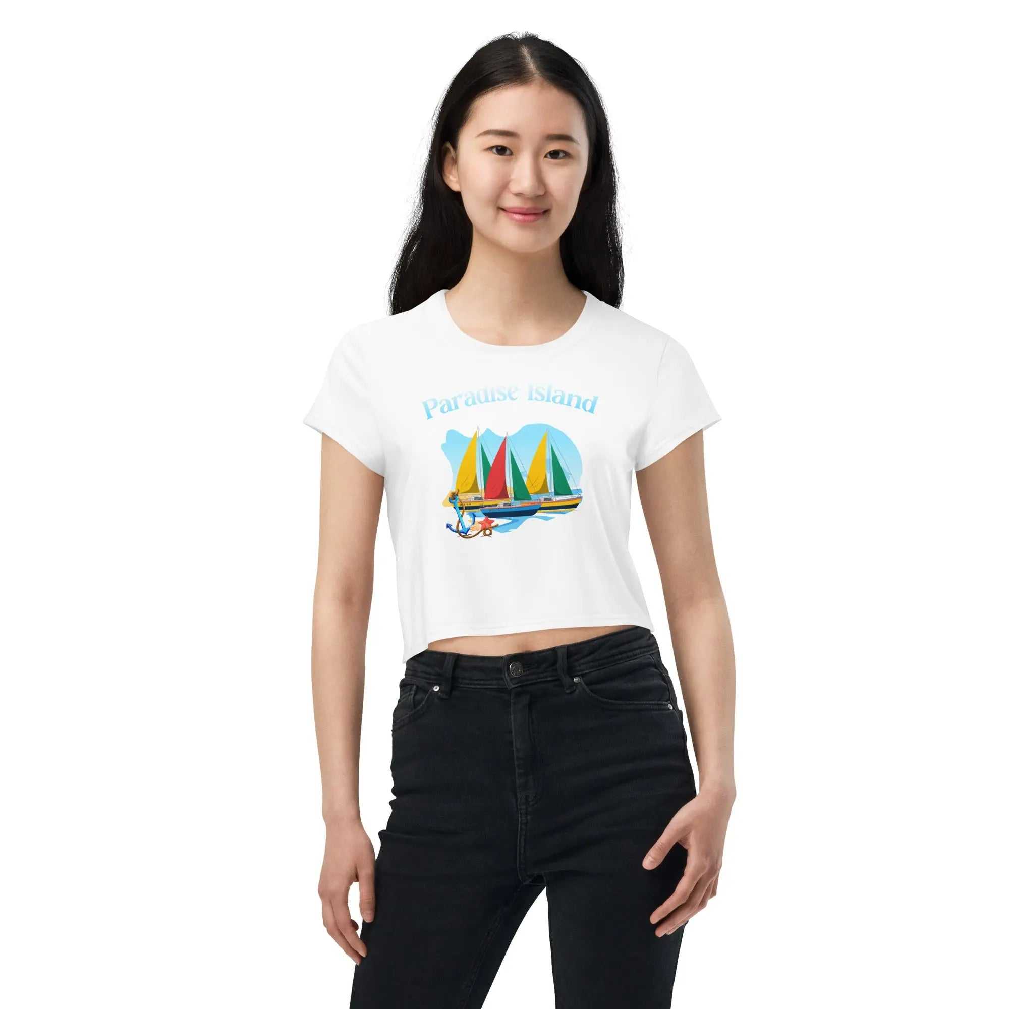 Woman wearing Paradise Island all-over print crop tee with colorful sailboat design and text on white fabric
