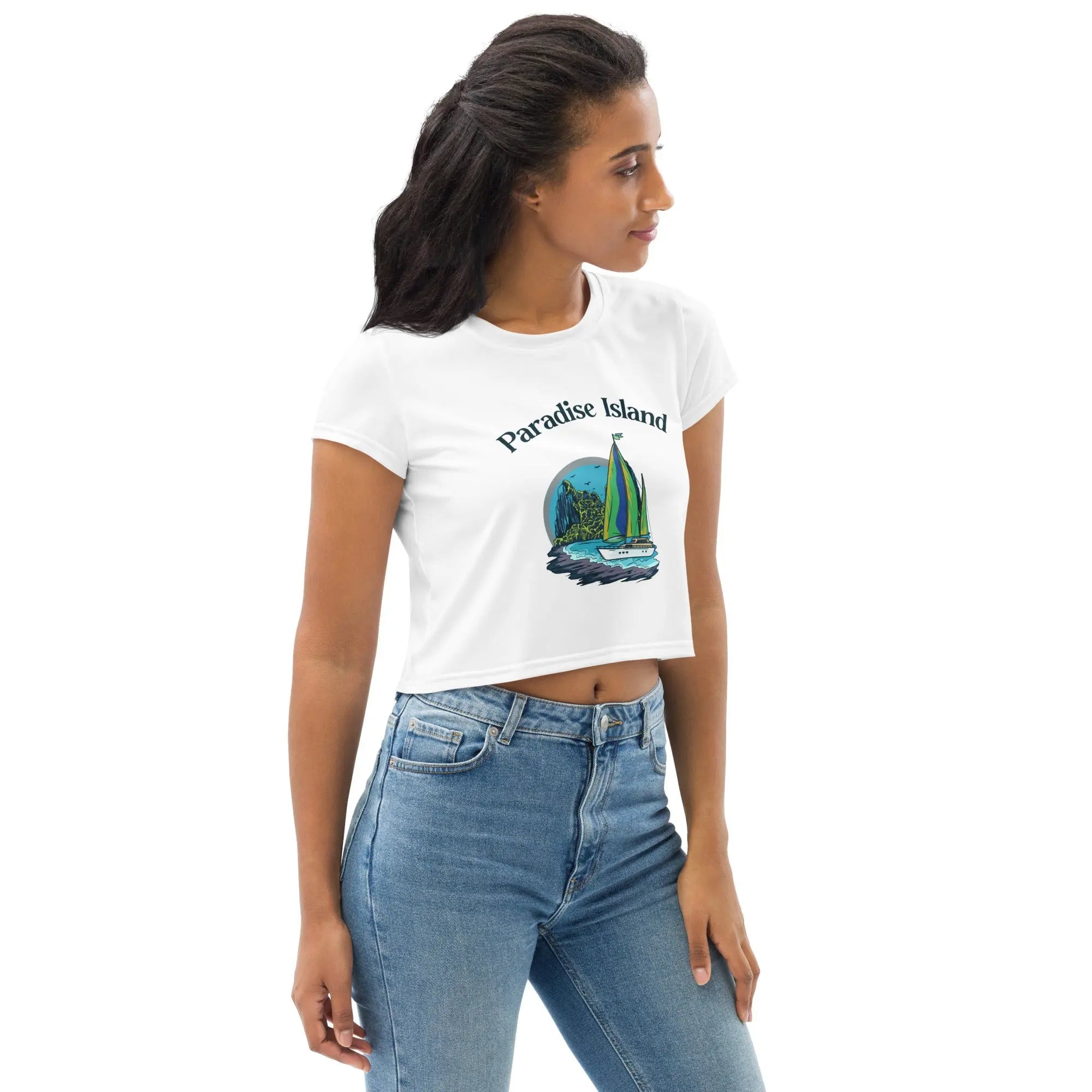 Woman wearing white Paradise Island all-over print crop tee with sailboat design and blue jeans