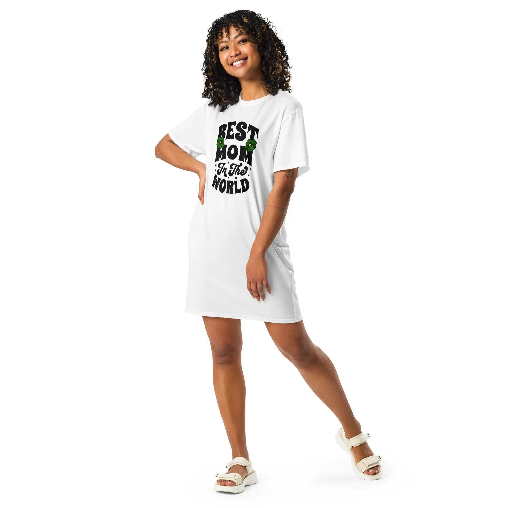 Woman wearing white Best Mom In The World tall t-shirt dress with bold lettering and floral accents