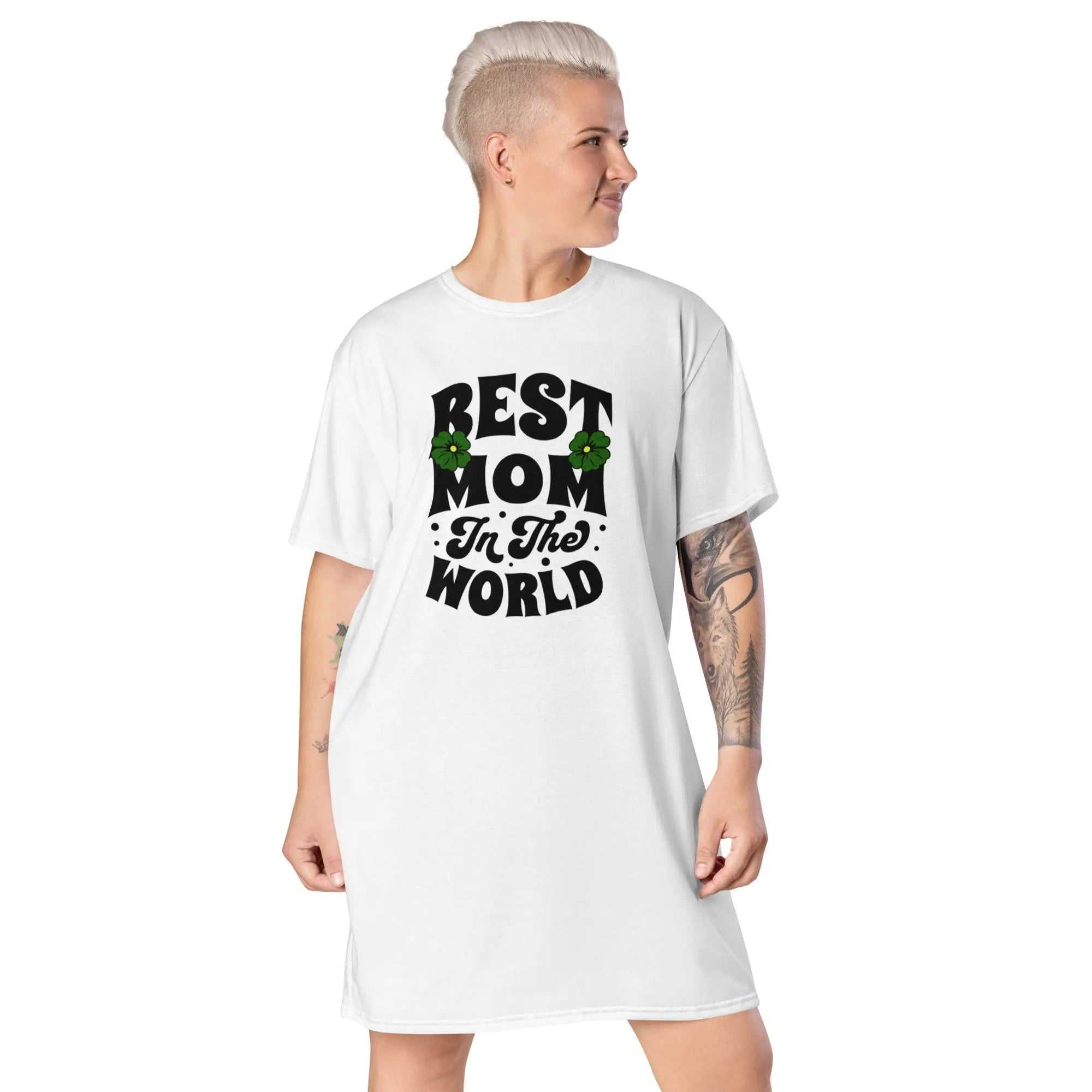 Woman wearing white Best Mom In The World ladies comfort tall t-shirt dress with bold black typography and floral accents