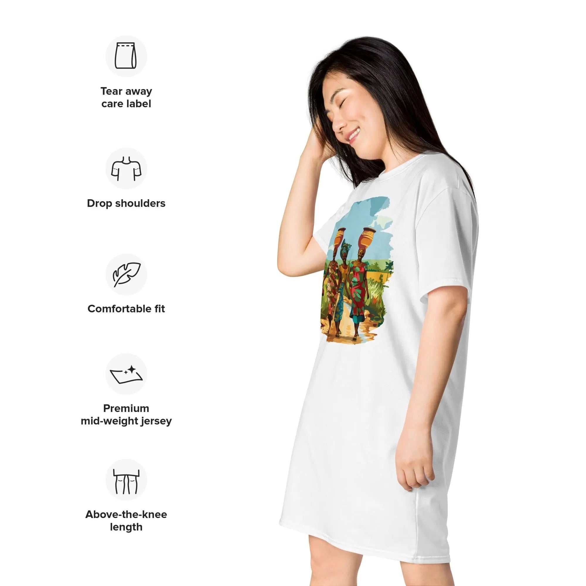 Woman wearing Africa Vibes Ladies Tall Comfort T-Shirt Dress with African Village Life design featuring three women in vibrant attire carrying water pots.