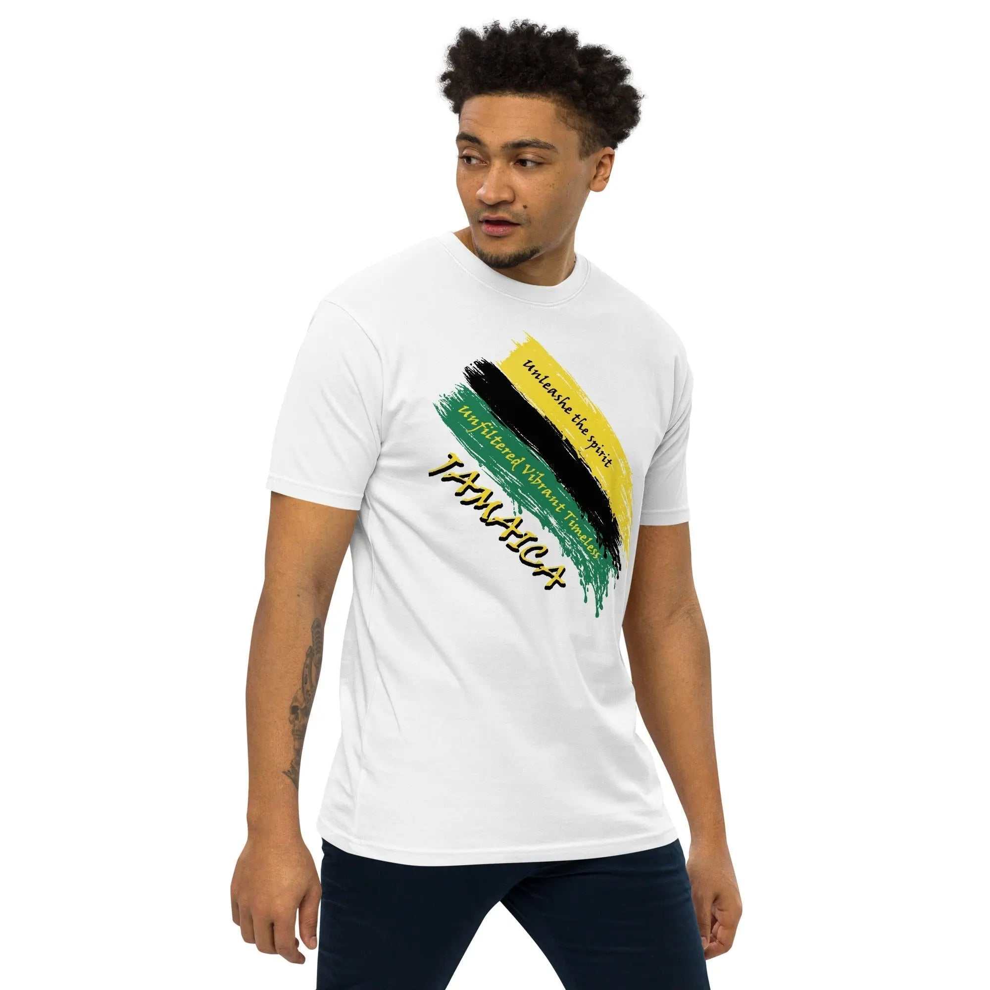 Man wearing Raw Unfiltered Jamaica Men’s Premium Heavyweight Tee with Jamaica-inspired brush stroke design in black, green, and gold on white fabric