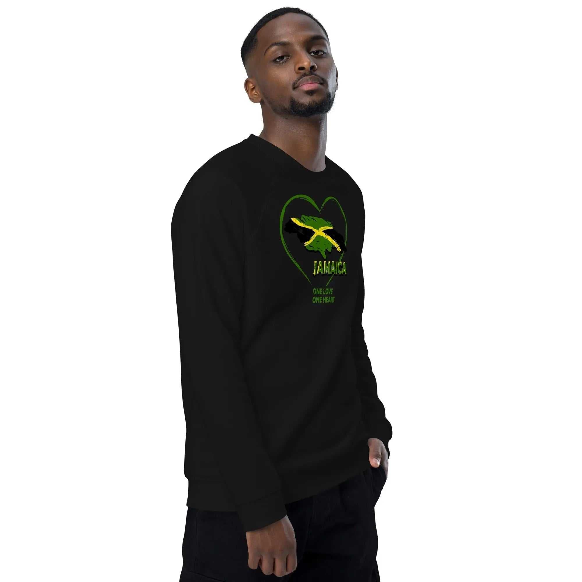 Man wearing black unisex organic raglan sweatshirt with Jamaica map and One Love One Heart design