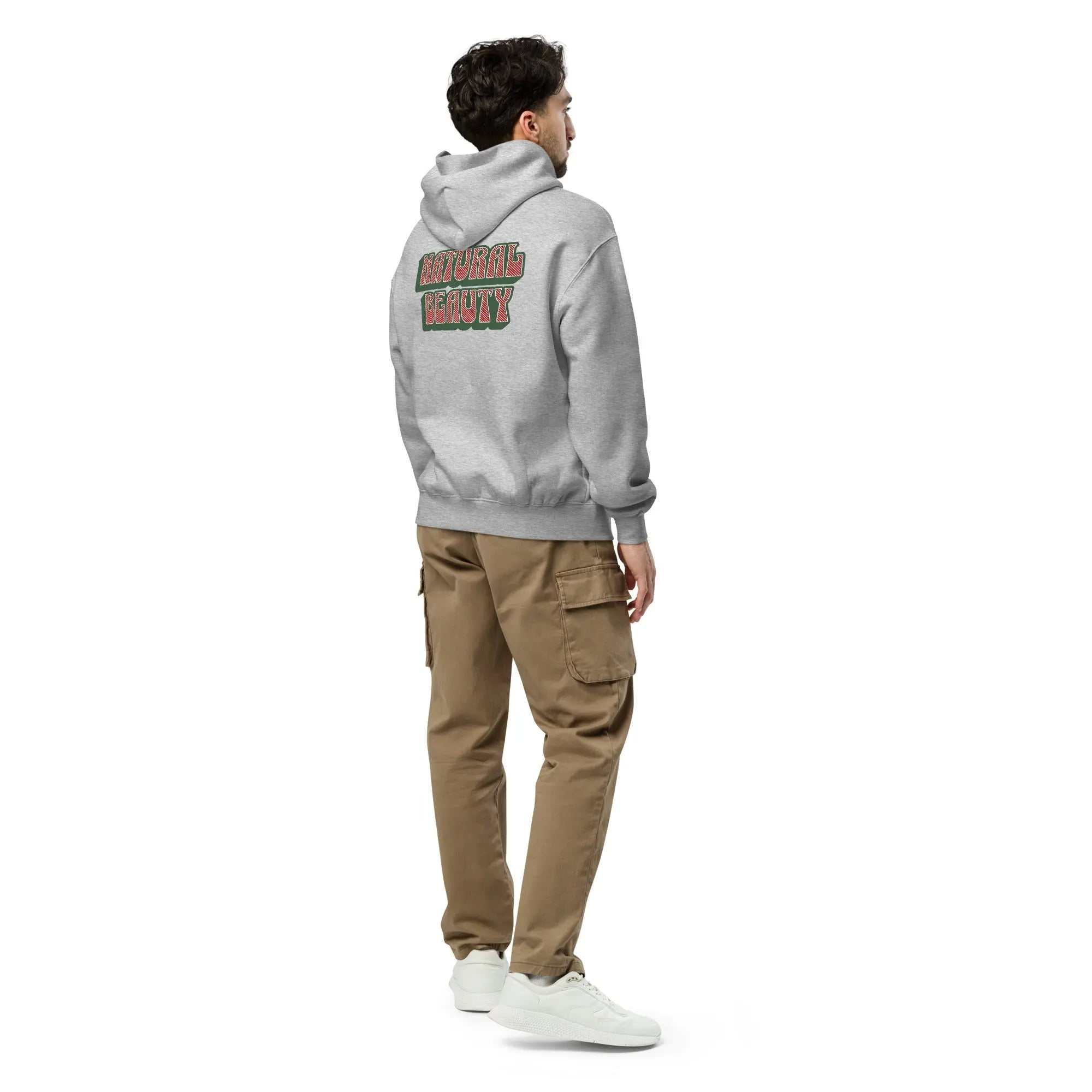 Man wearing gray Natural Beauty hoodie with graphic text on back, paired with brown cargo pants and white sneakers, showcasing relaxed unisex fit.
