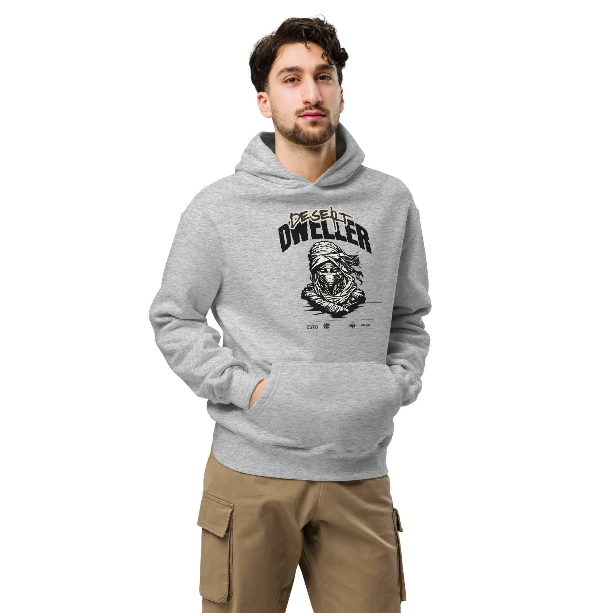 Man wearing gray Desert Dweller hoodie with front kangaroo pocket and graphic design, styled with khaki pants
