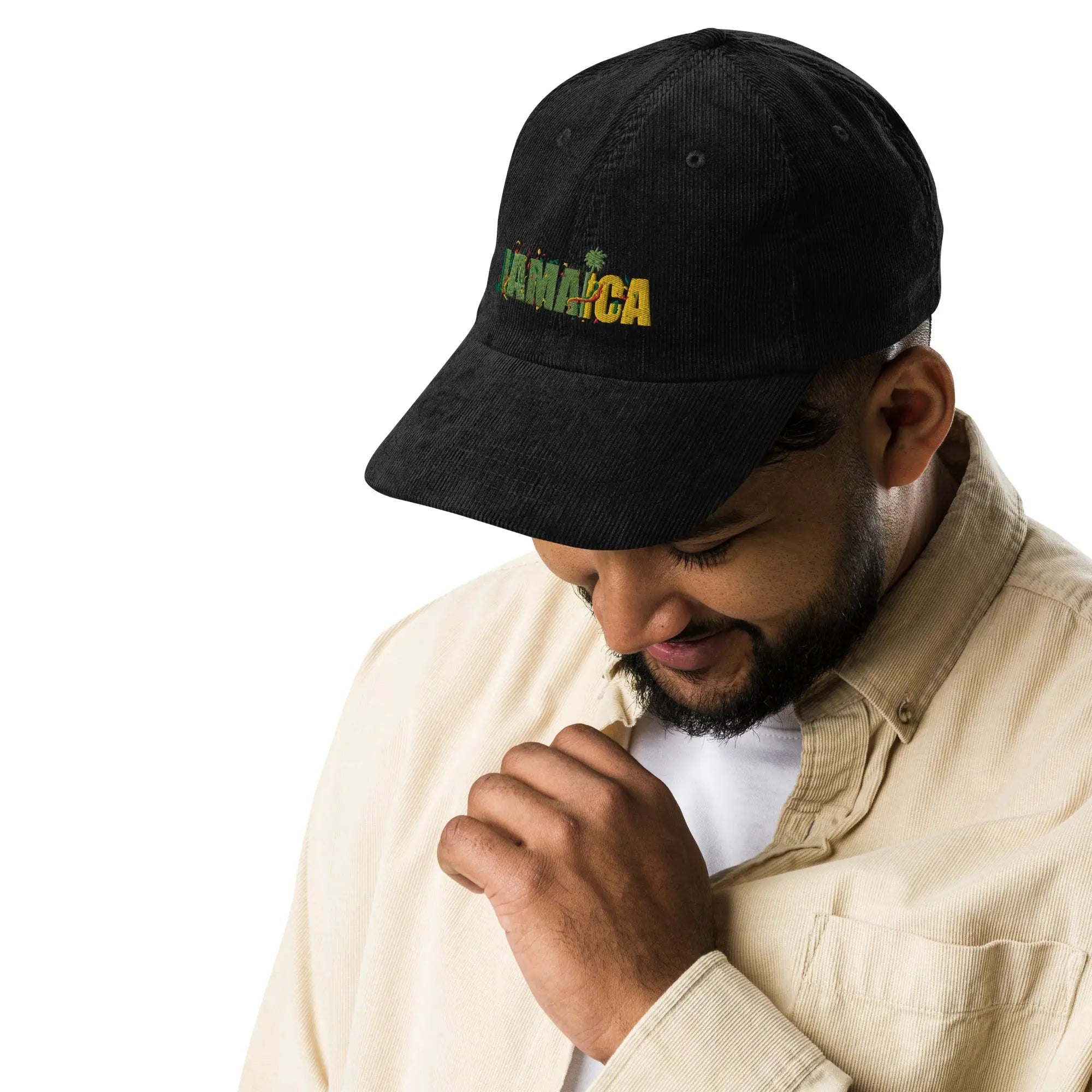 Man wearing black Jamaica Vintage Corduroy cap with embroidered logo and adjustable strap