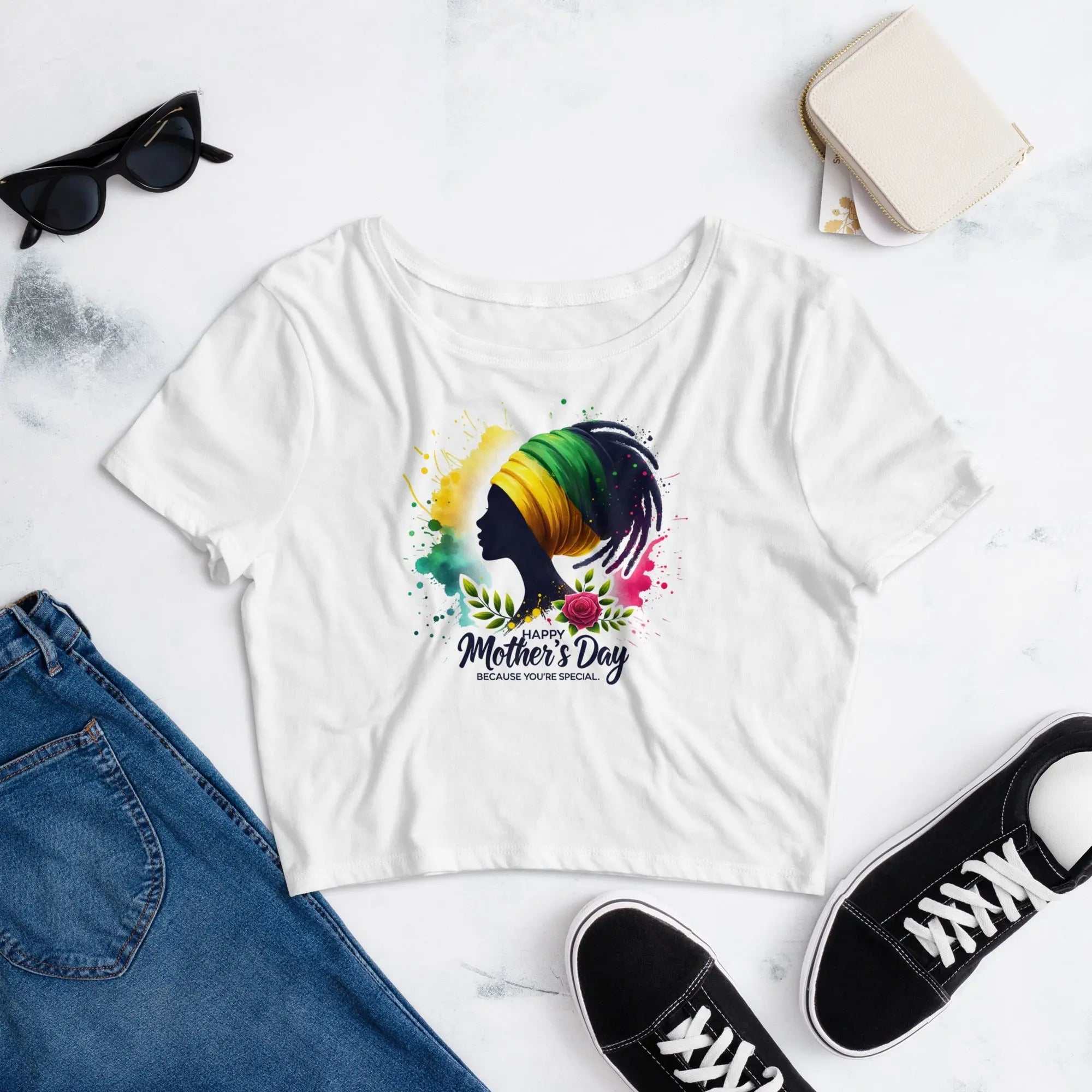 White Mothers Day Women’s crop tee with colorful silhouette design, paired with jeans, sunglasses, and sneakers on white background
