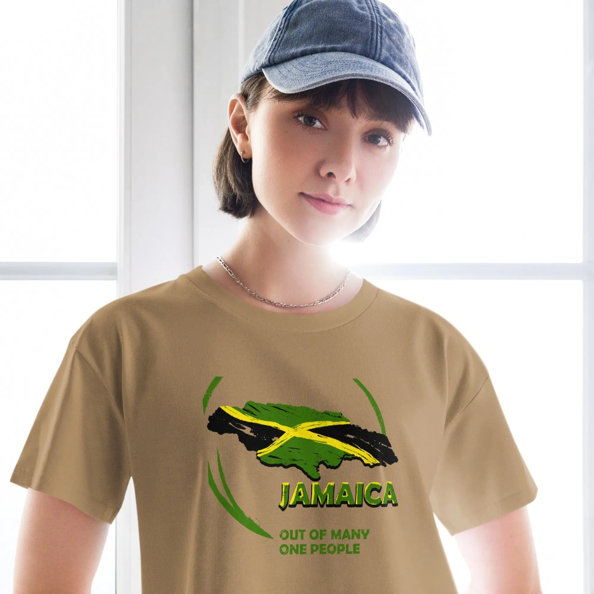 Woman wearing beige Out Of Many One People crop top featuring Jamaica map with national flag colors and slogan