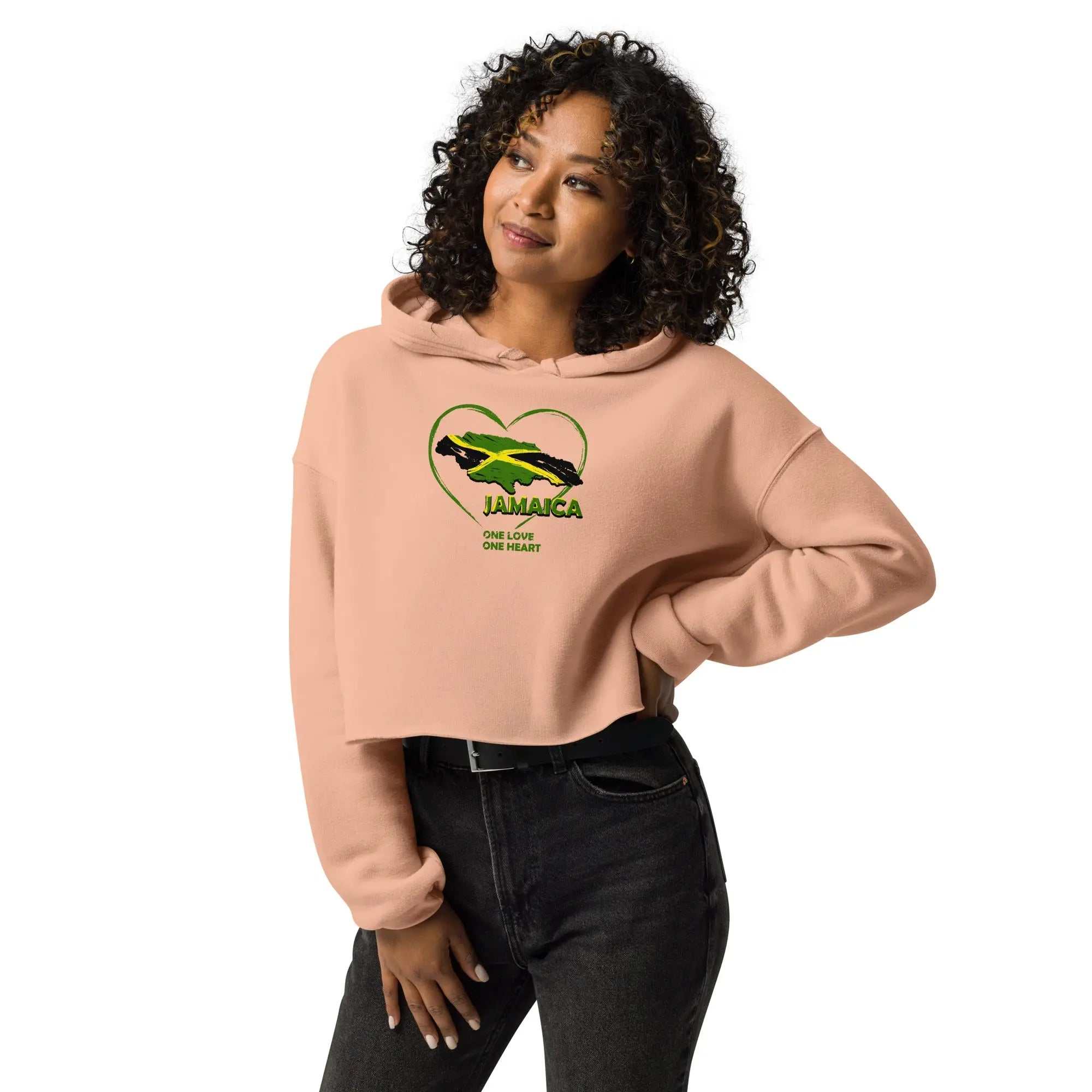 Woman wearing peach One Love One Heart cropped hoodie with raw hem and Jamaica heart graphic
