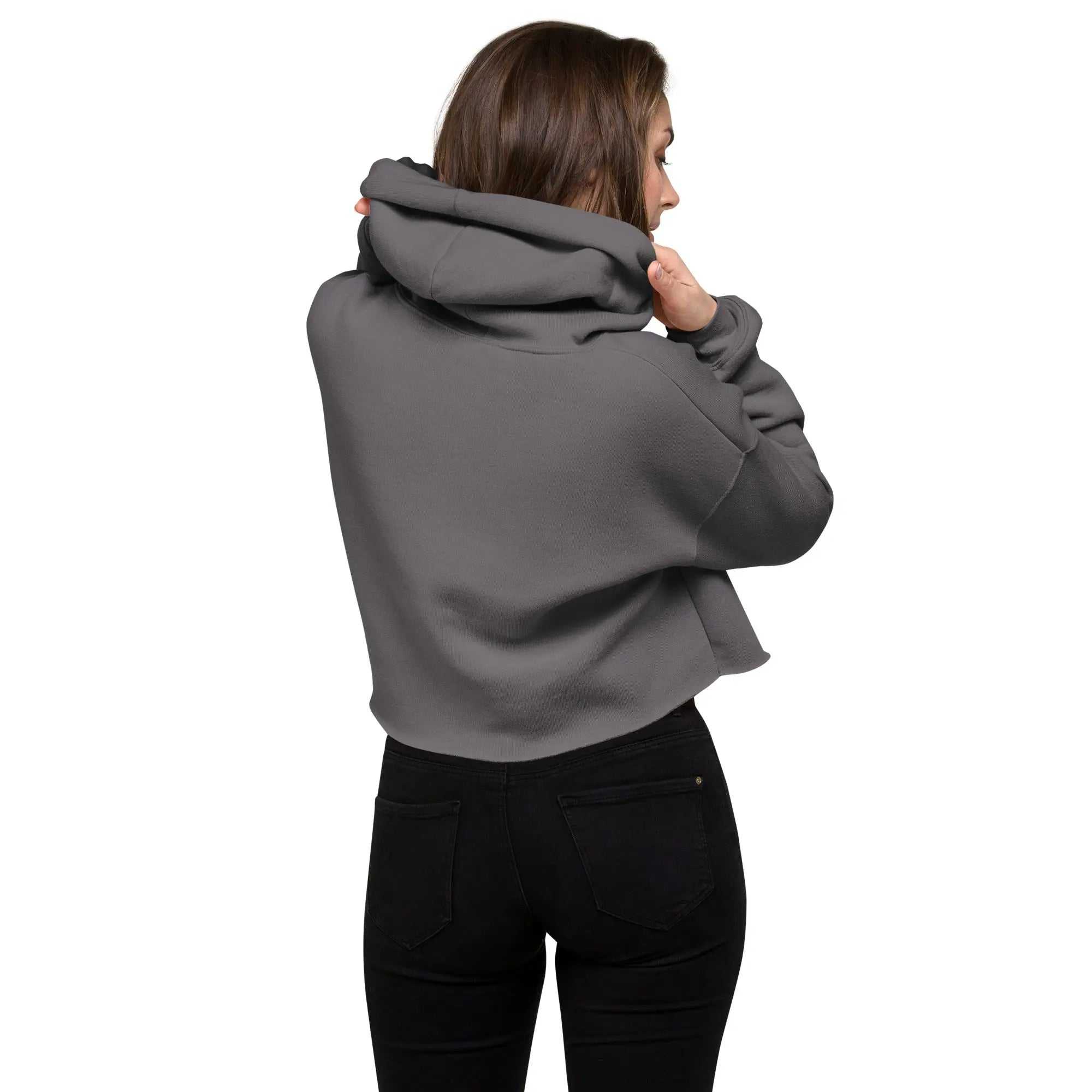 Woman wearing a gray Ladies Crop Hoodie with raw hem and dropped shoulder, shown from the back