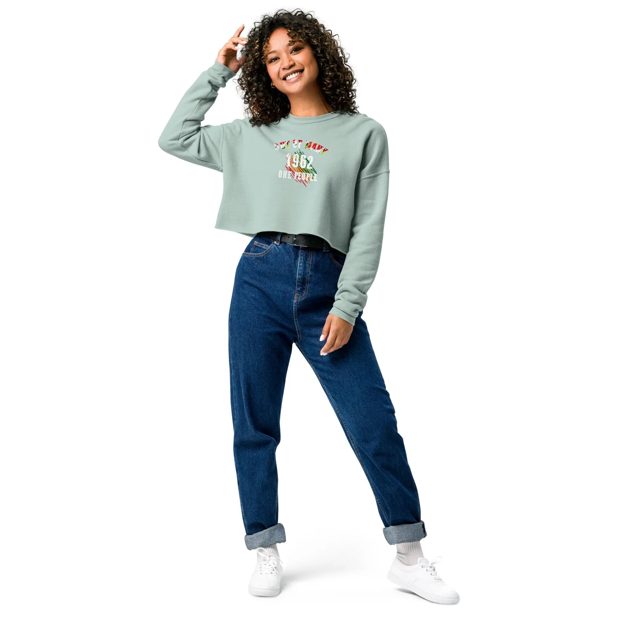 Woman wearing Out Of Many One People crop sweatshirt with 1962 design and blue jeans