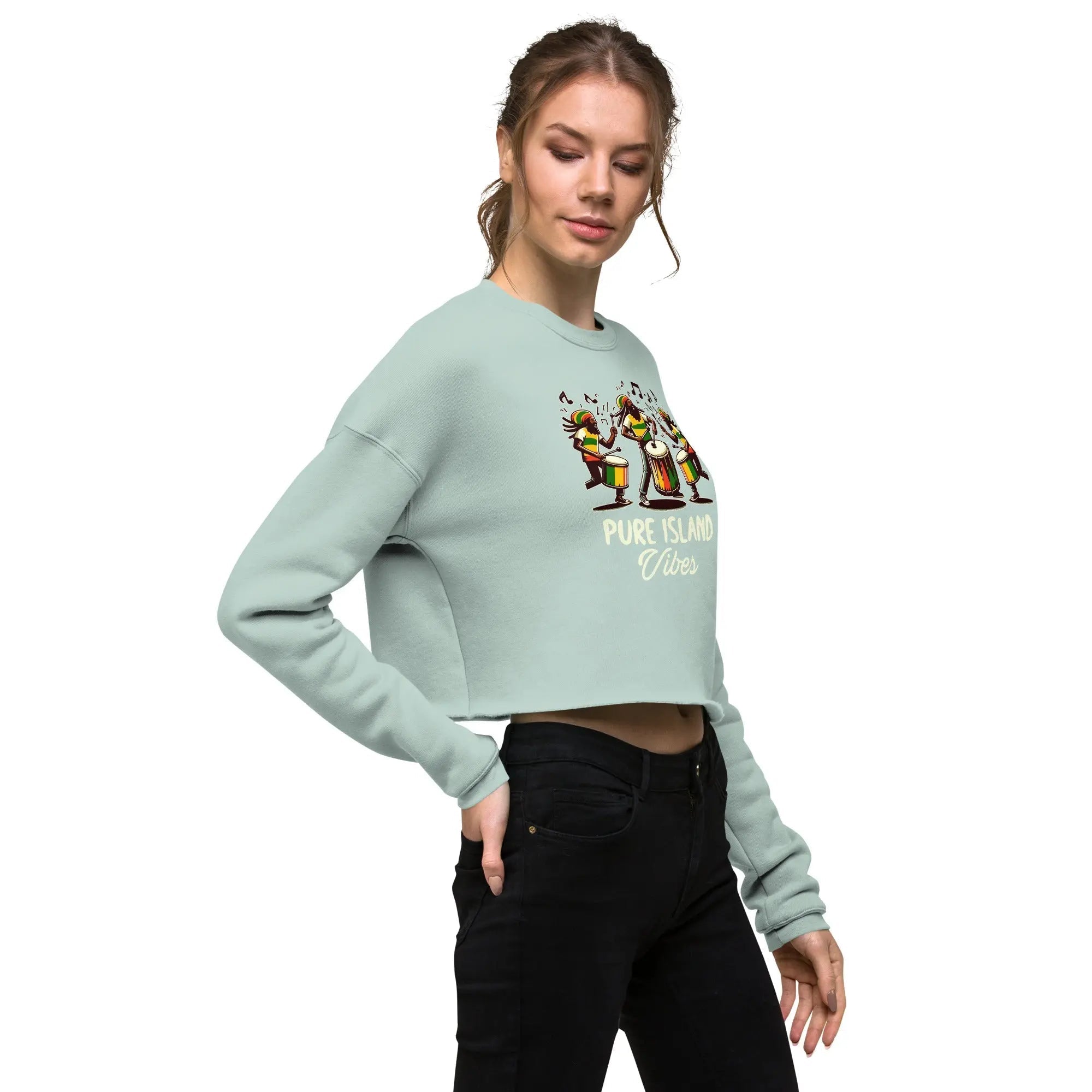 woman wearing a mint green Pure Island Vibes crop sweatshirt with colorful drummers graphic and black pants