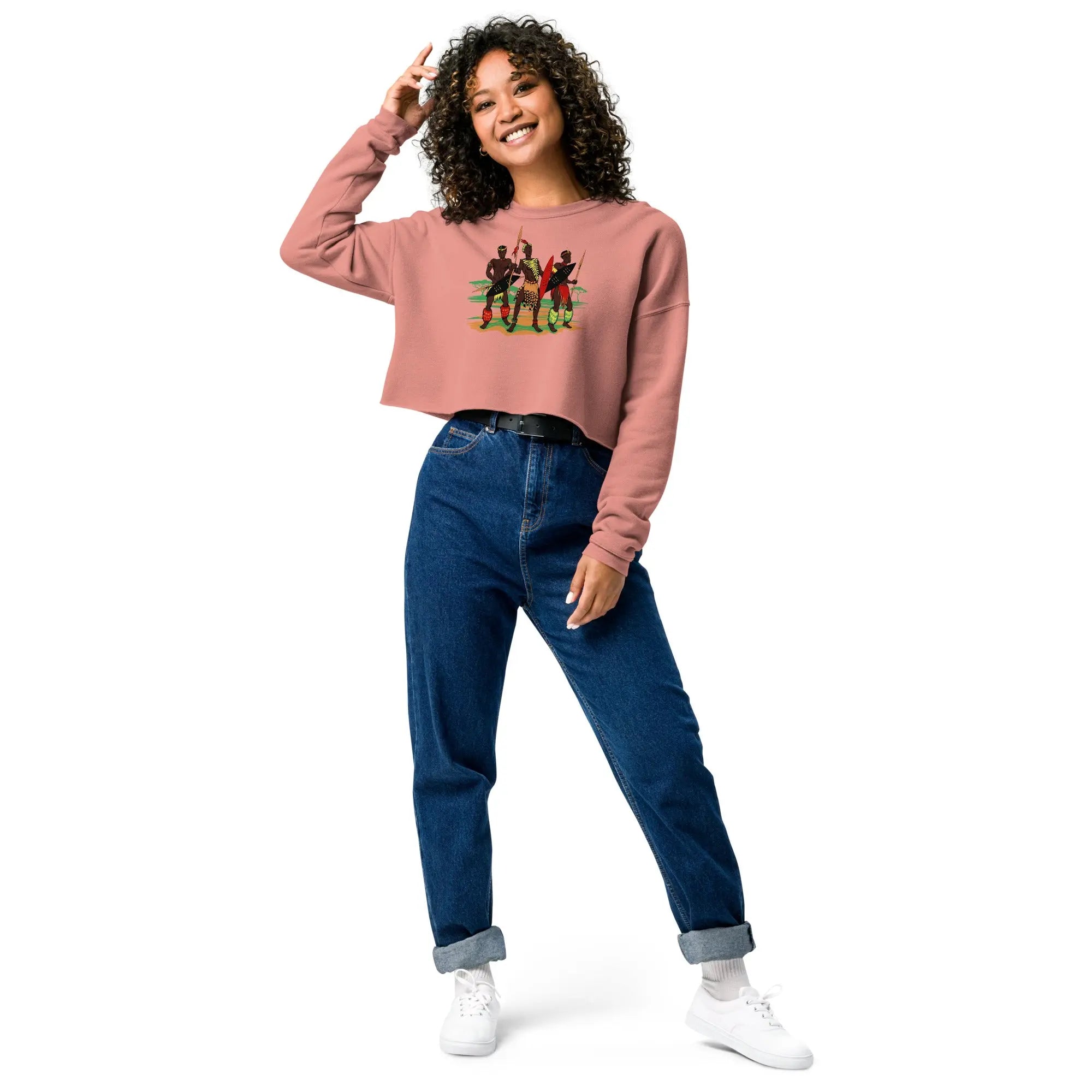 Woman wearing African Zulu Worriers crop sweatshirt with three warriors graphic, paired with blue jeans and white sneakers