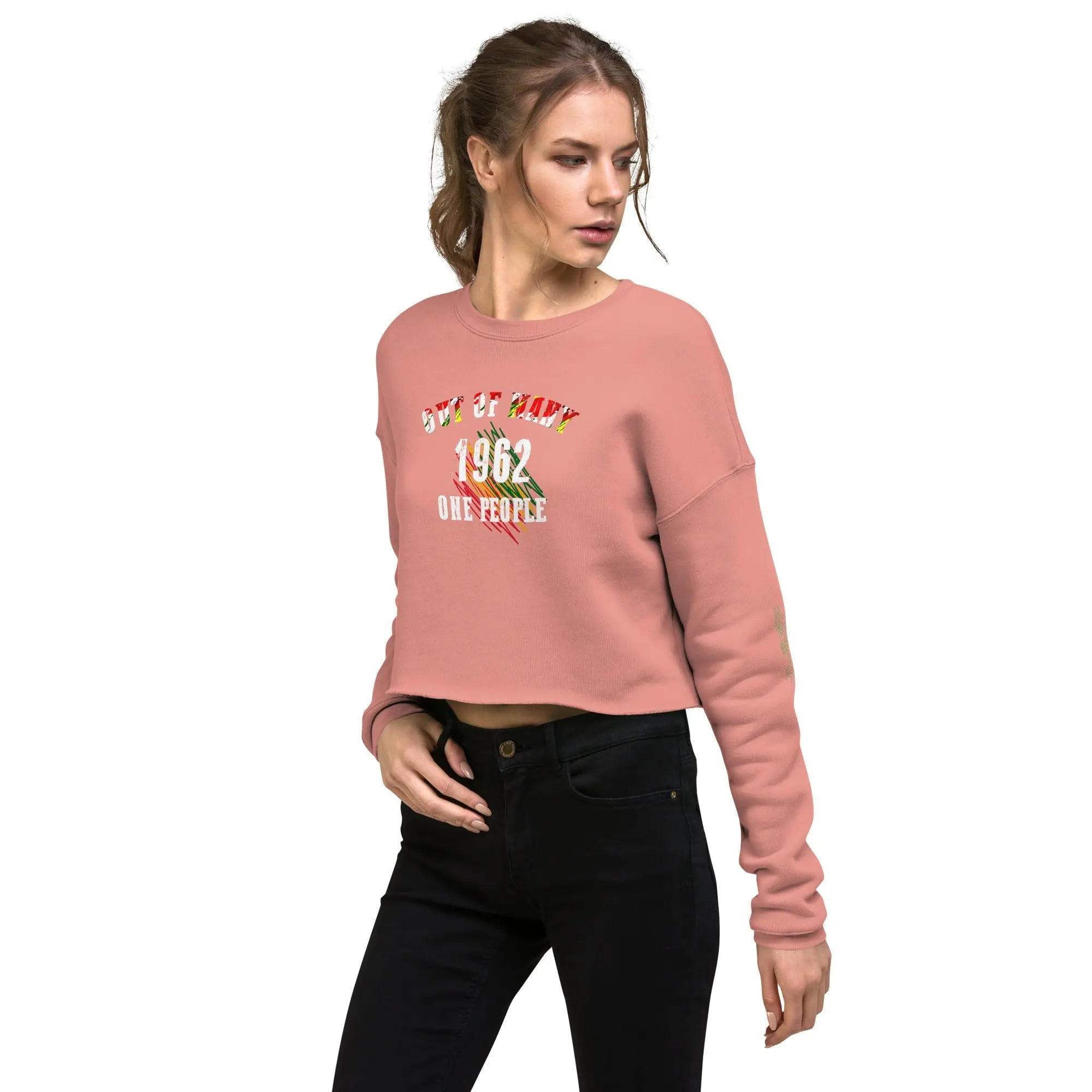 Woman wearing Out Of Many One People 1962 cropped sweatshirt in pink with bold typography and vibrant pattern